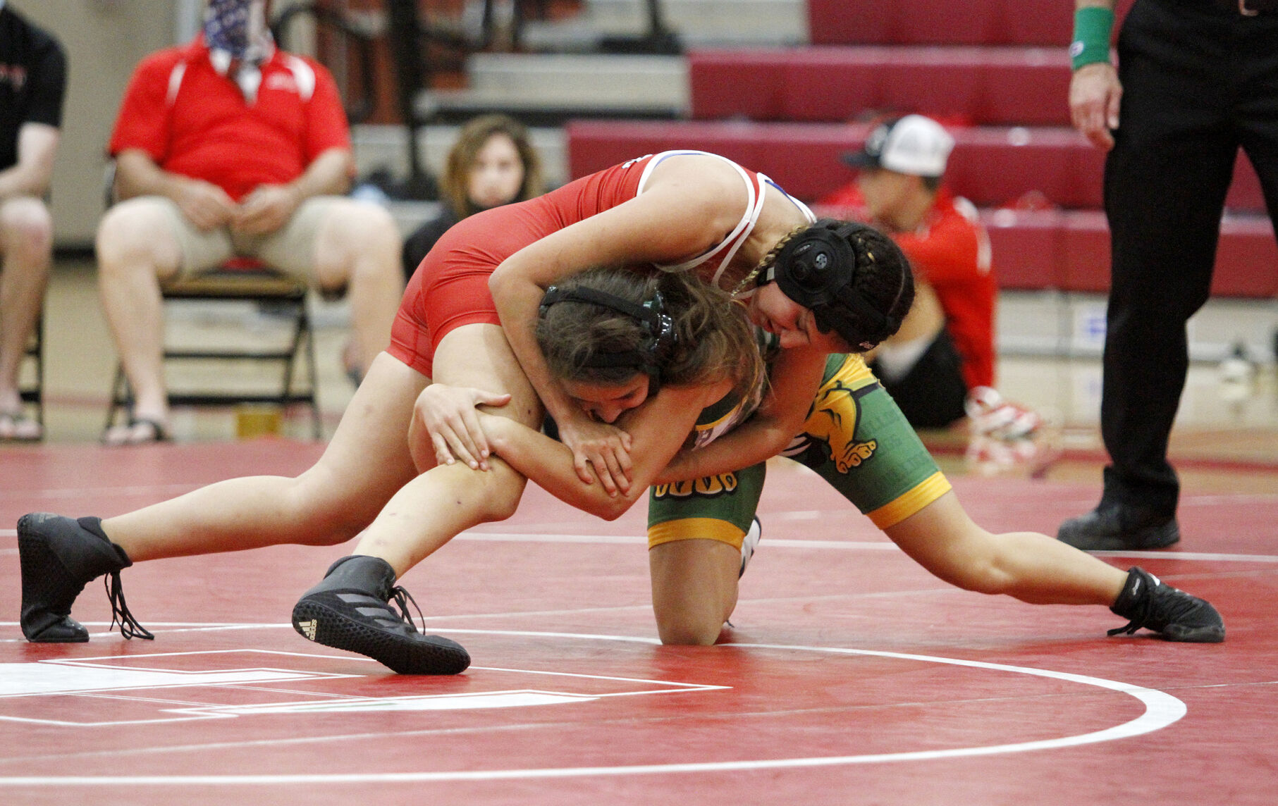 High school roundup: Flames’ boys and girls wrestlers take down Bulldogs